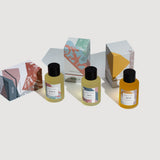 Verdant Alchemy natural bath oils laid down on a grey background.