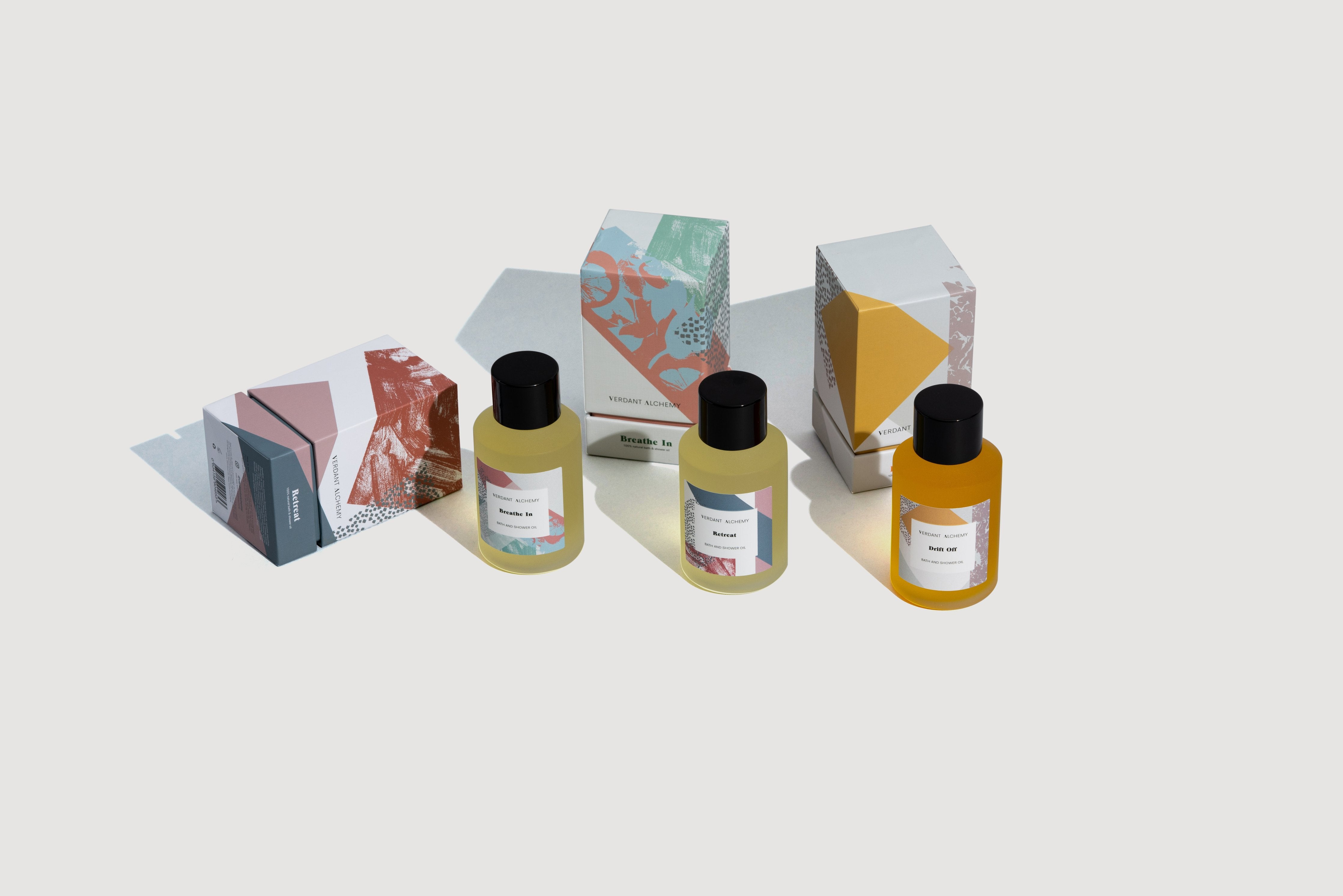 Verdant Alchemy natural bath oils laid down on a grey background.